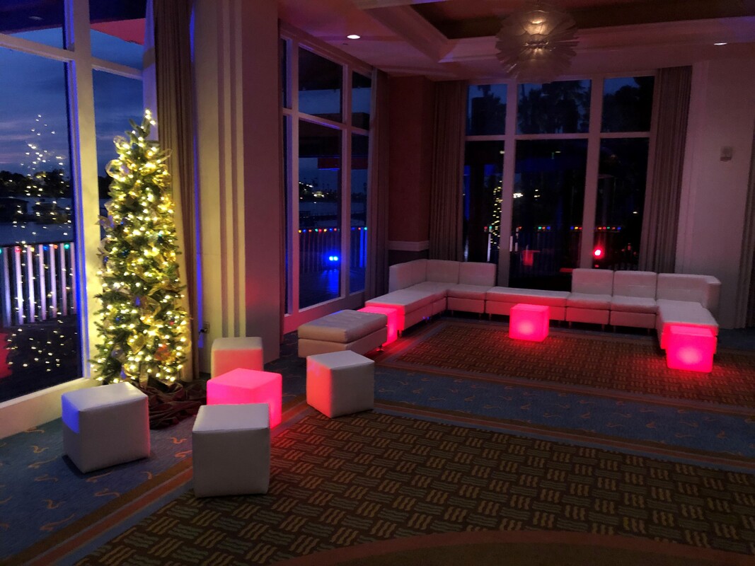 Holiday Party with Christmas Tree and White Lounge Furniture with Red LED lights